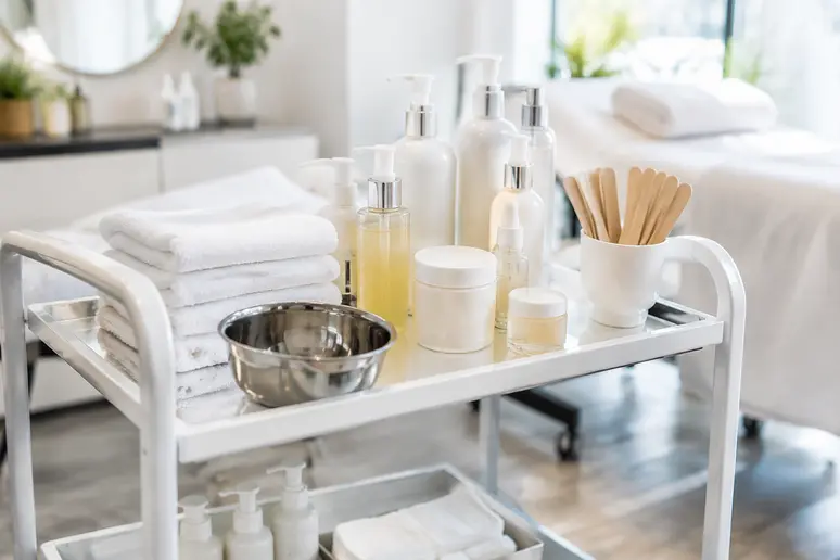 Chariot de soins avec lingettes en coton et produits professionnels dans un institut
